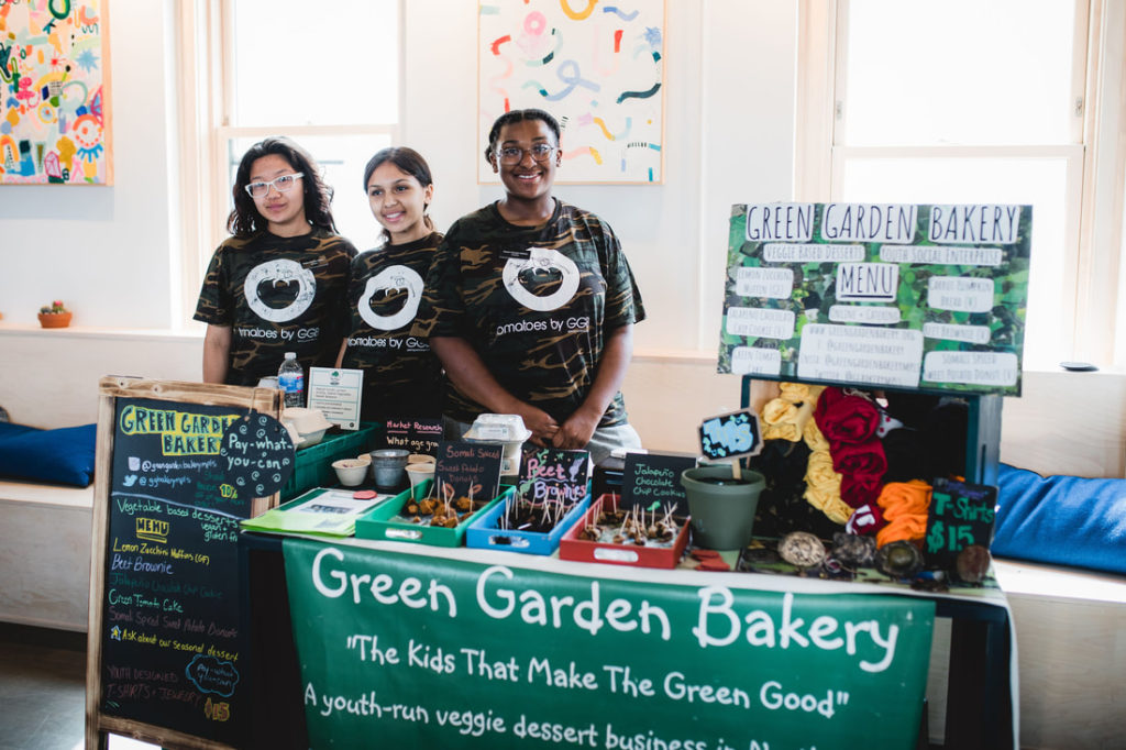 Youth working in a Green Garden Bakery booth